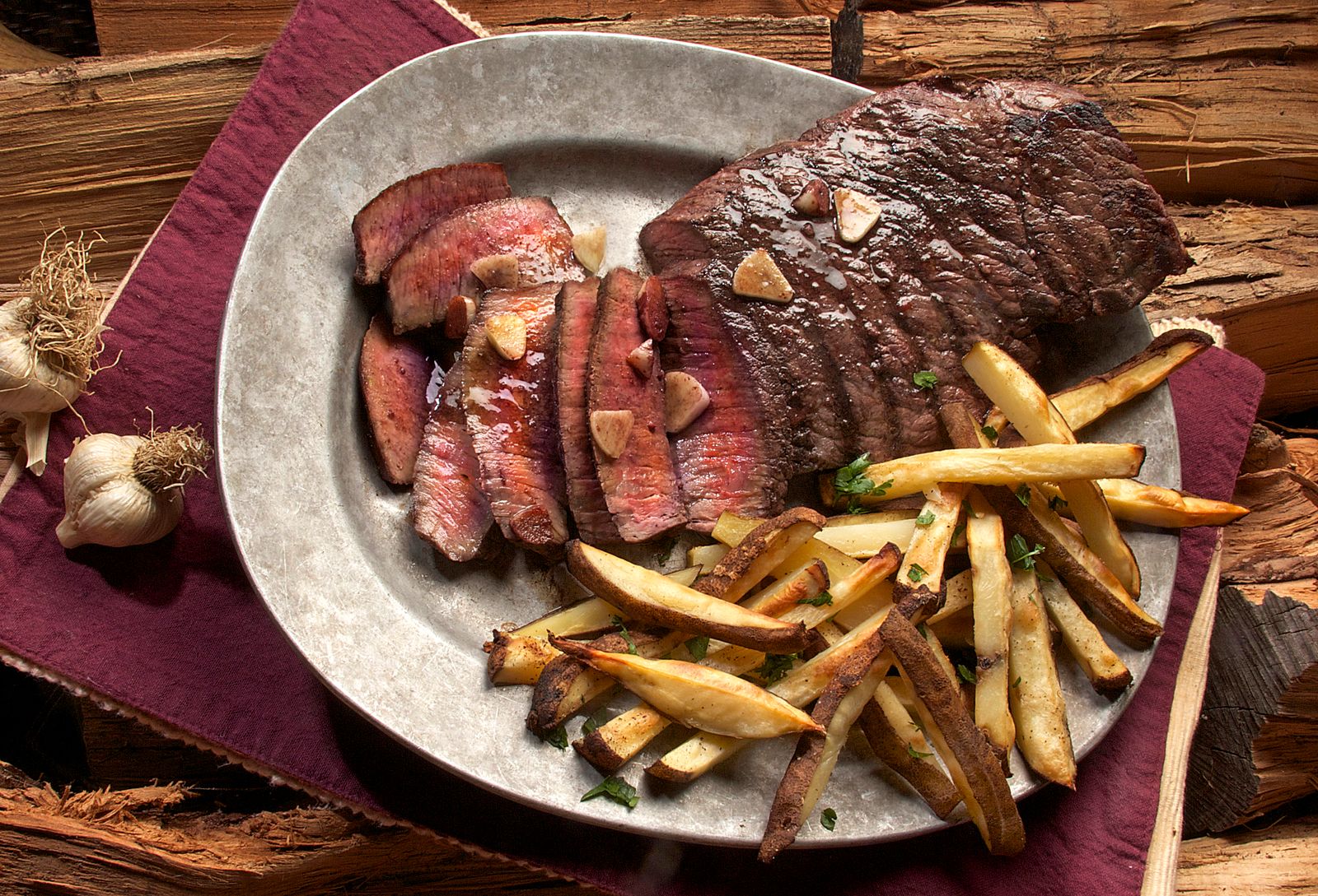 Steak and fries on a metal plate